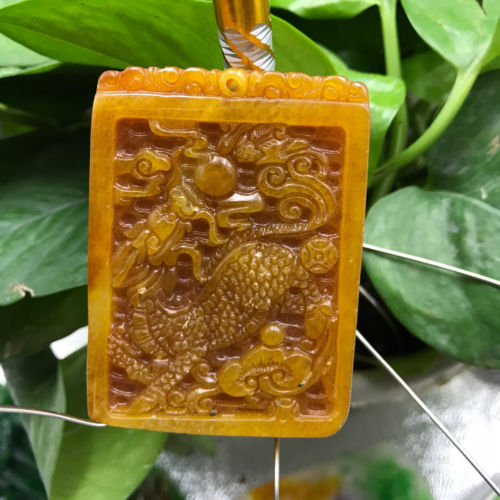 Pre-Conjure Golden Dragon in Hand Carved Gold Jade Pendant Pre-Conjure Golden Dragon in Hand Carved Gold Jade Pendant